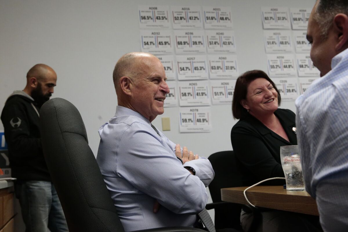 SACRAMENTO, CA, TUESDAY, NOVEMBER 4, 2014 -Relaxed after his easy victory over challenger Neel Kashkari, Jerry Brown checks the progress of State Democratic candidates at campaign headquarters with former Assembly Speaker John Perez, right, and current Assembly Speaker Toni Atkins. (Robert Gauthier/Los Angeles Times)