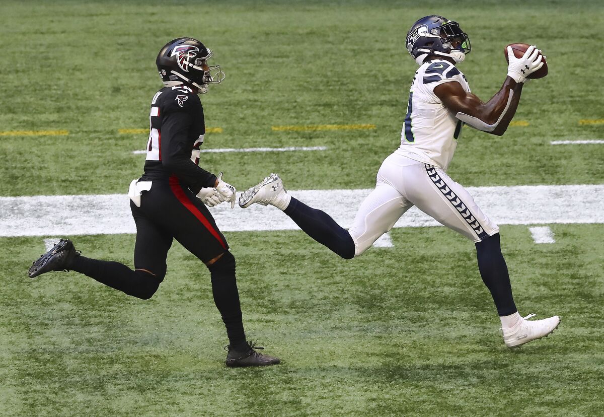 Seattle Seahawks wide receiver DK Metcalf catches a touchdown pass past Atlanta Falcons cornerback Isaiah Oliver during the second half of an NFL football game on Sunday, Sept. 13, 2020, in Atlanta. (Curtis Compton/Atlanta Journal-Constitution via AP)