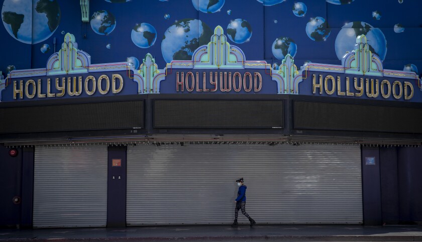 A pedestrian on a mostly empty sidewalk in Hollywood on Wednesday.
