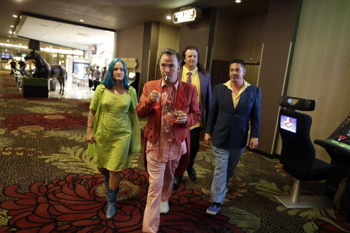 Comedian Doug Stanhope, front, and his girlfriend, Amy “Bingo” Bingaman, walk through the Plaza hotel in Las Vegas.