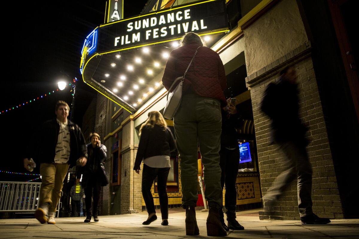 People walk past the Egyptian Theatre, a landmark venue showing films during the 2018 Sundance Film Festival.