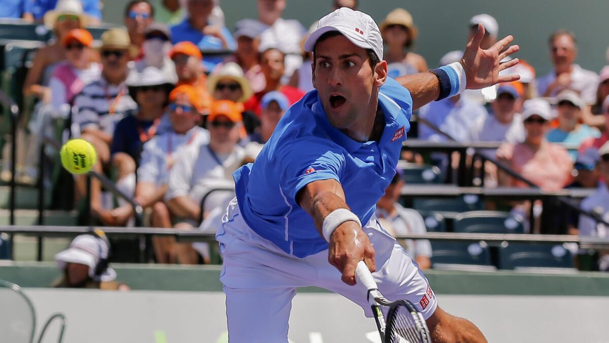 Novak Djokovic lunges on a return during his victory over Andy Murray in the Miami Open final on Sunday.