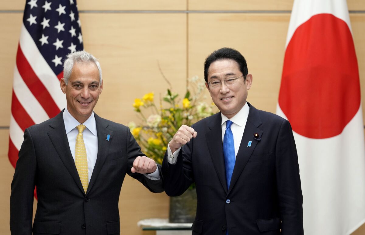 Rahm Emanuel, left, new U.S. Ambassador to Japan, elbow-bumps with Japan's Prime Minister Fumio Kishida at the start of their meeting at the prime minister's official residence in Tokyo, Japan, Friday, Feb. 4, 2022. (Franck Robichon/Pool Photo via AP)