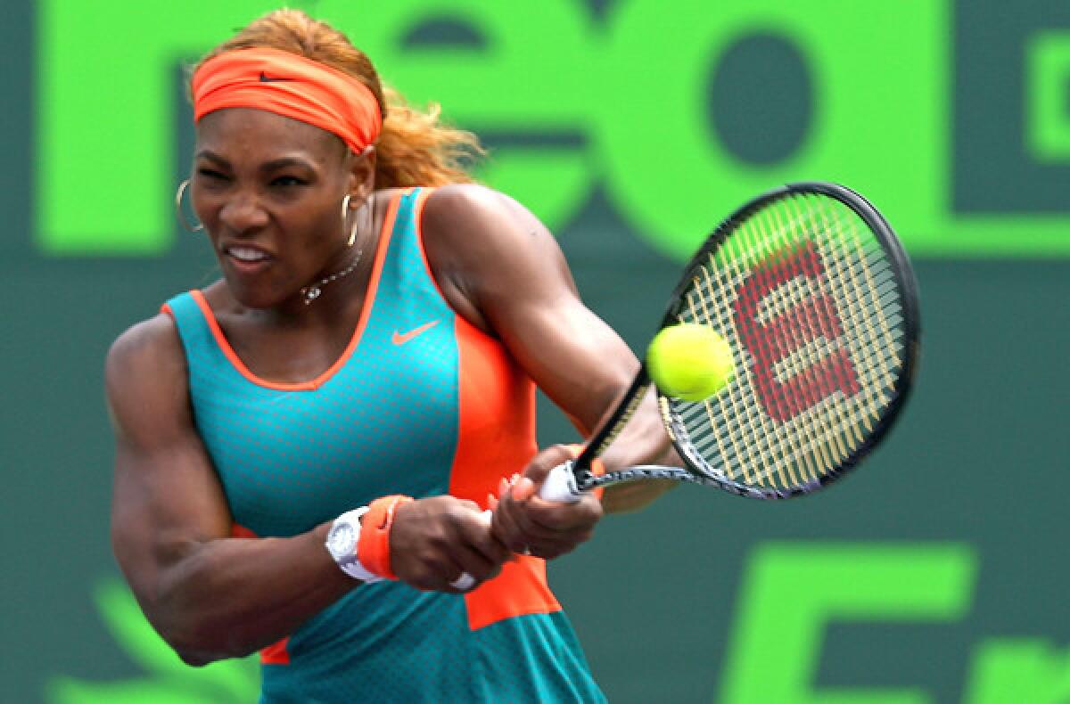 Serena Williams returns a shot to Maria Sharapova during their match on Thursday at the Sony Open in Key Biscayne, Fla.