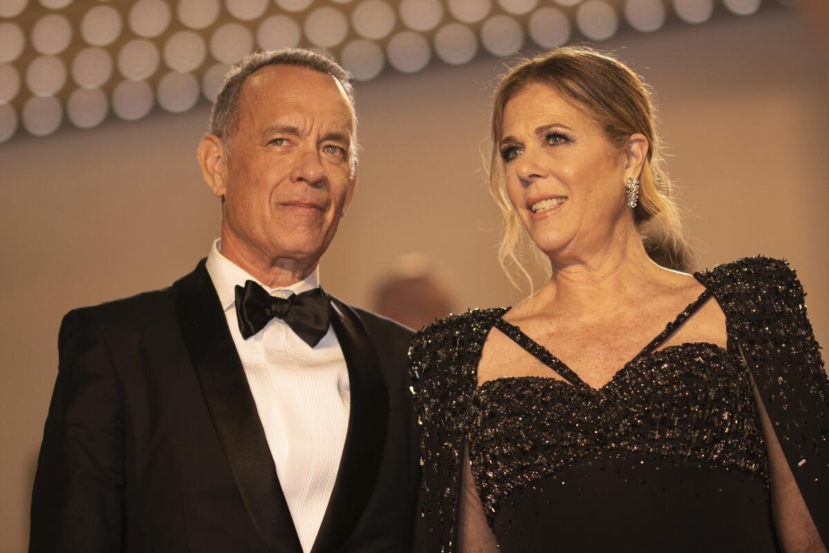 A man in a tuxedo and a woman in a black dress.