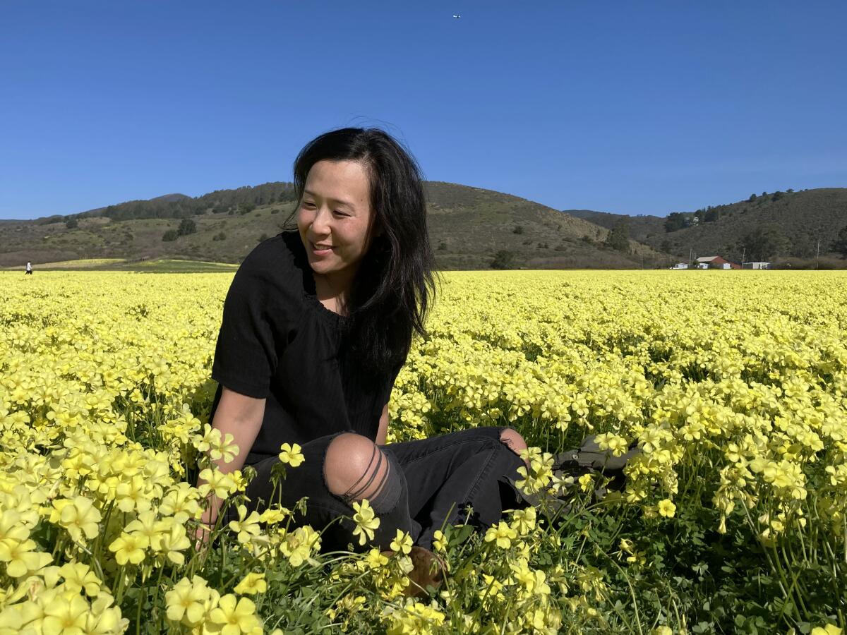 Leah Nichols in a field of yellow flowers near Pacifica.