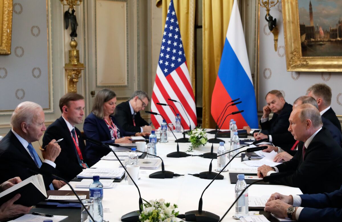 U.S President Joe Biden, left, and Russian President Vladimir Putin, right, talk.