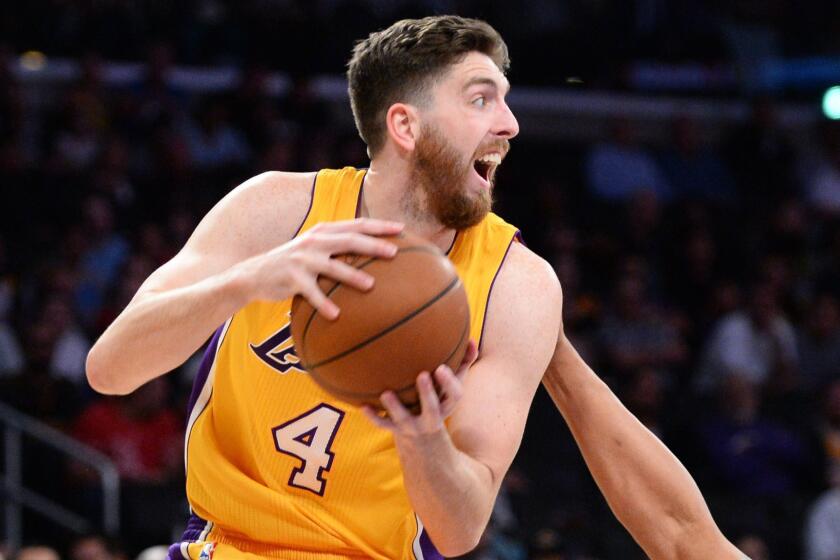 Lakers forward Ryan Kelly looks to pass during a game against the Detroit Pistons on March 10.