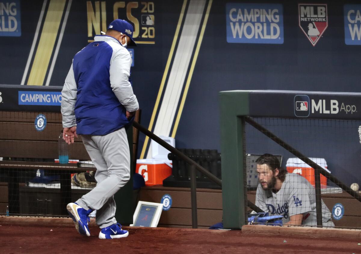 Clayton Kershaw sits in the dugout moments after being removed from the game in the sixth inning.