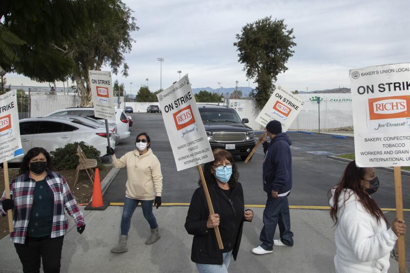 Workers at Jon Donaire Desserts factory in Santa Fe Springs picket in front of the company Monday.
