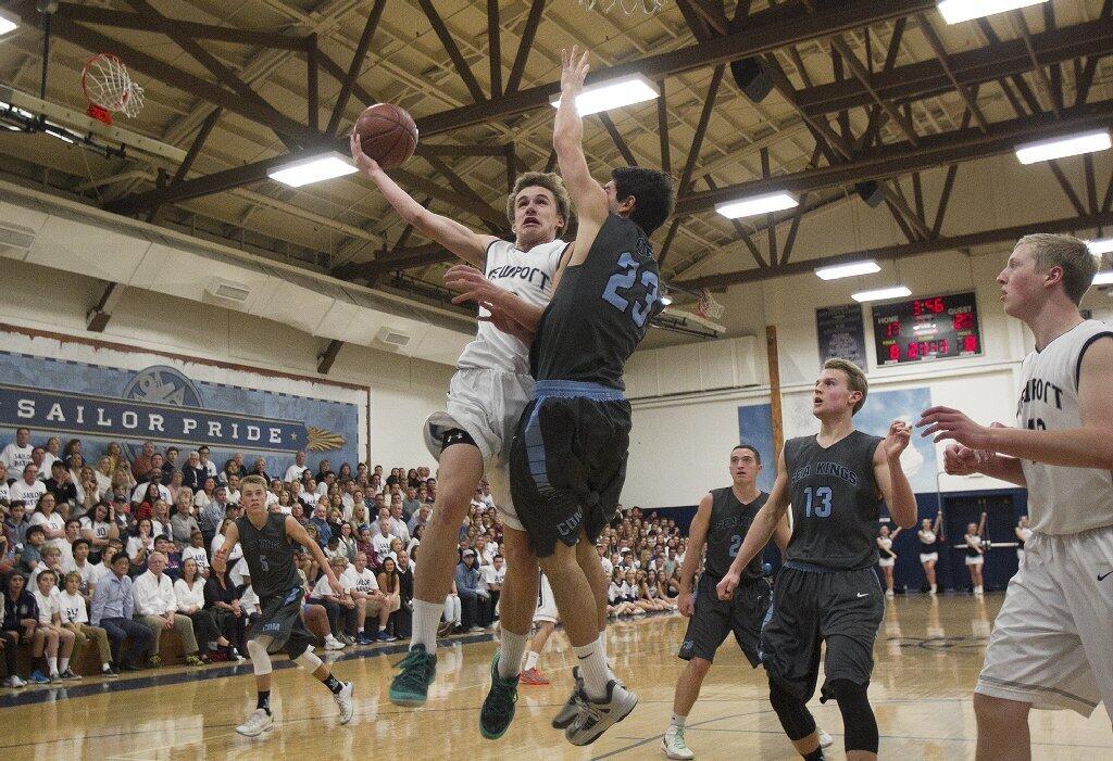 Newport Harbor High's Joey Faris goes up for a shot against Corona del Mar's Ryan Stone during the Battle of the Bay on Saturday.