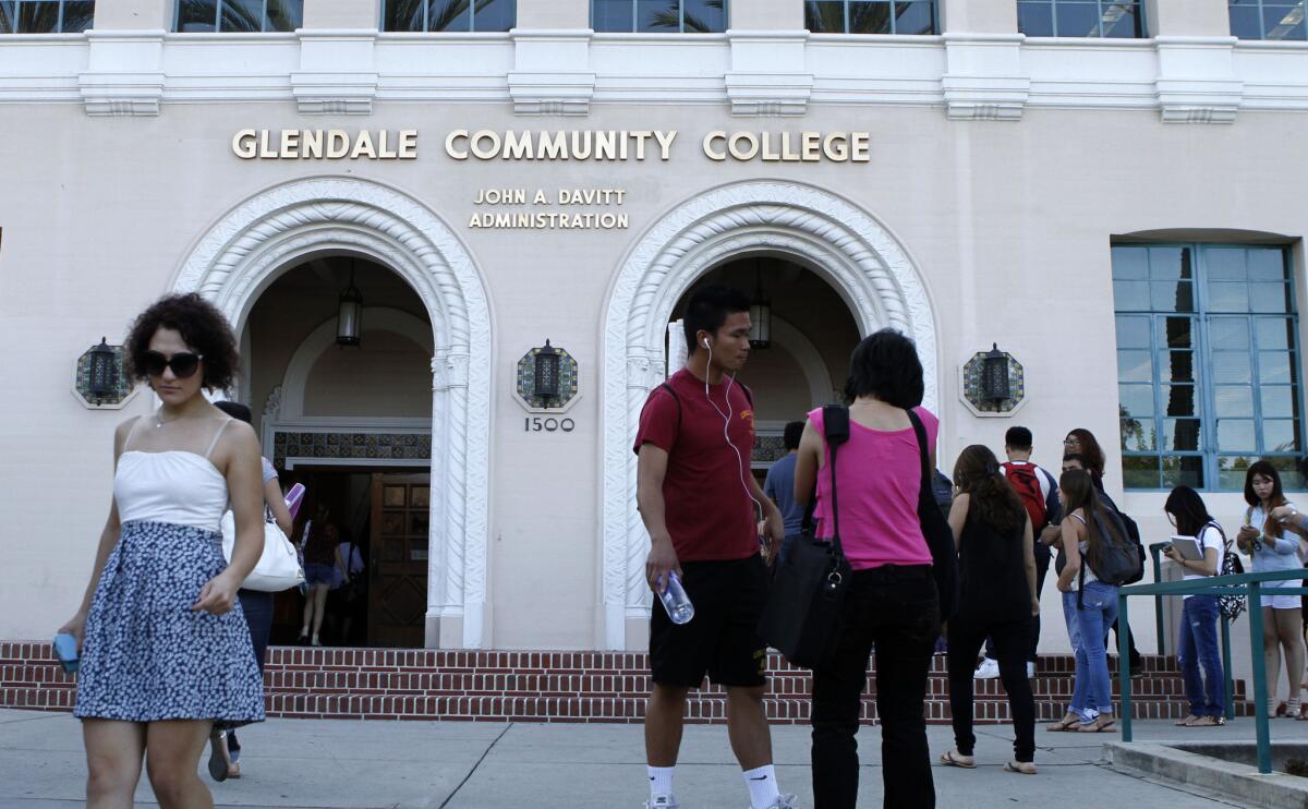 Some students rush to and from buildings as others wait in line on the first day of Fall classes at Glendale Community College on Tuesday, September 3, 2013.