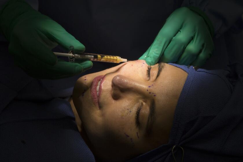 BEVERLY HILLS, CA - MAY 22, 2017: Marc Mani performs MIST (Minimally Invasive Stromal Transfer), an alternative to Botox to patient Mia Belle, 35. (Myung J. Chun / Los Angeles Times)