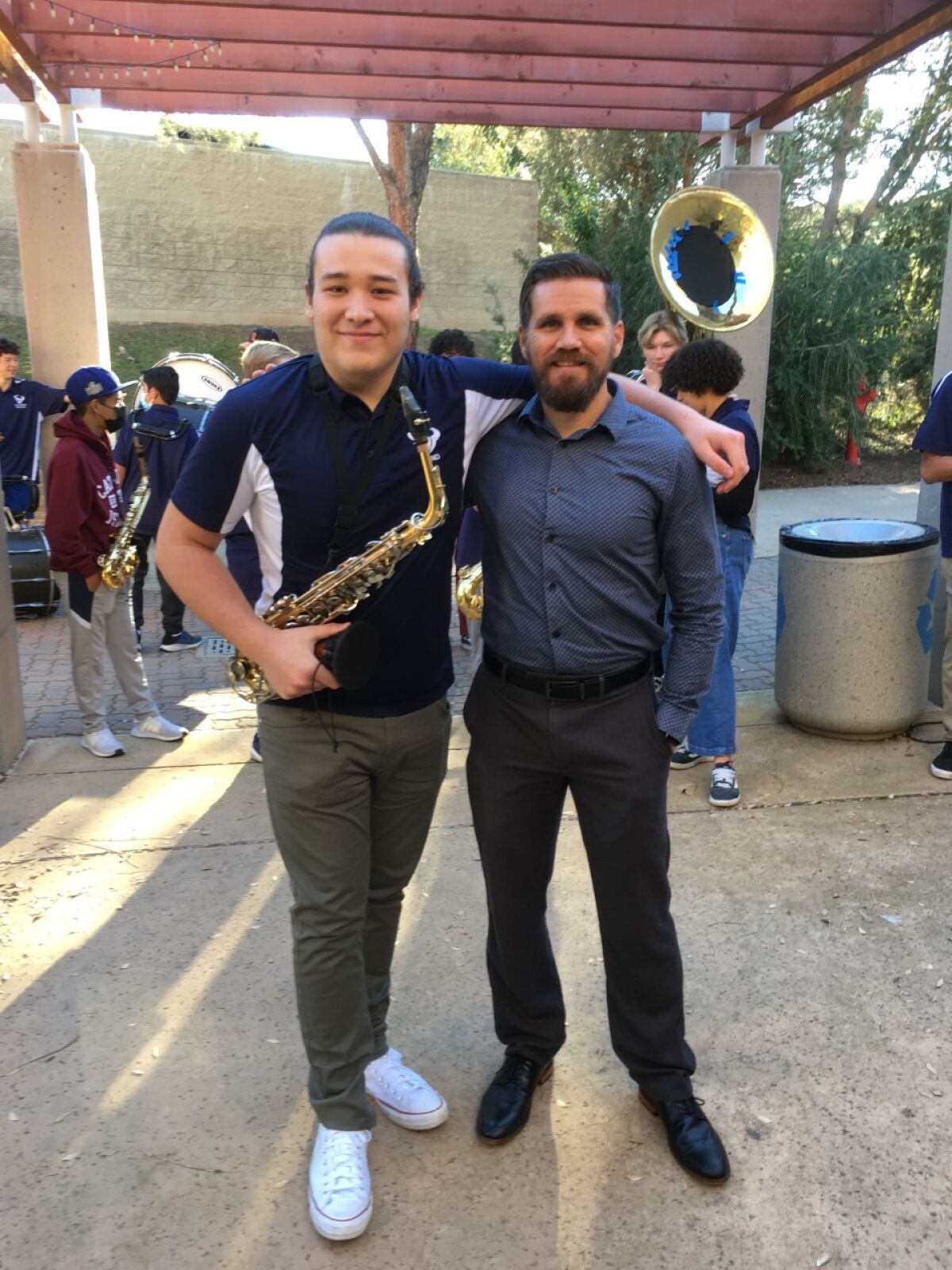 Ian West, drum major at La Costa Canyon High School, with Band Director Charles Mekealian.