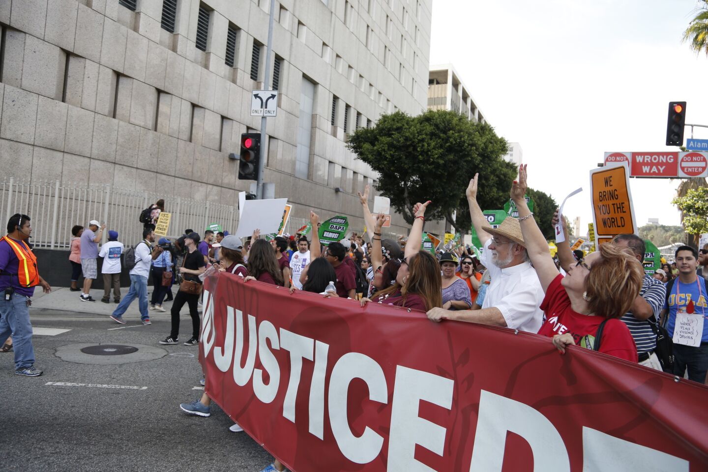 Protesters walk past the Metropolitan Detention Center during a May Day March in downtown Los Angeles.