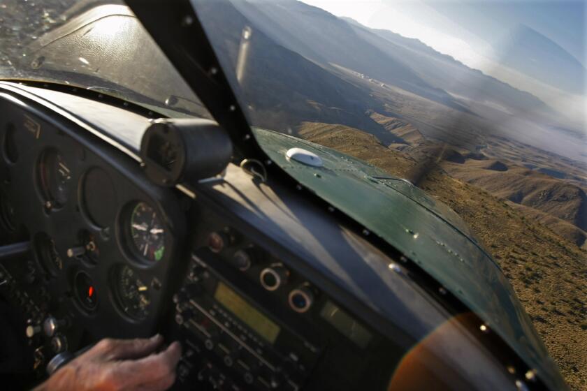 A pilot flies over a mountain pass and descends towards a dry lake bed named the Racetrack inside Death Valley National Park, CA. This is the same flight route that Sinaloa Cartel drug pilot John Ward described in a prison interview as using to reach the Racetrack. He made illegal landings here to delivery marijuana he smuggled across the border from Mexico.