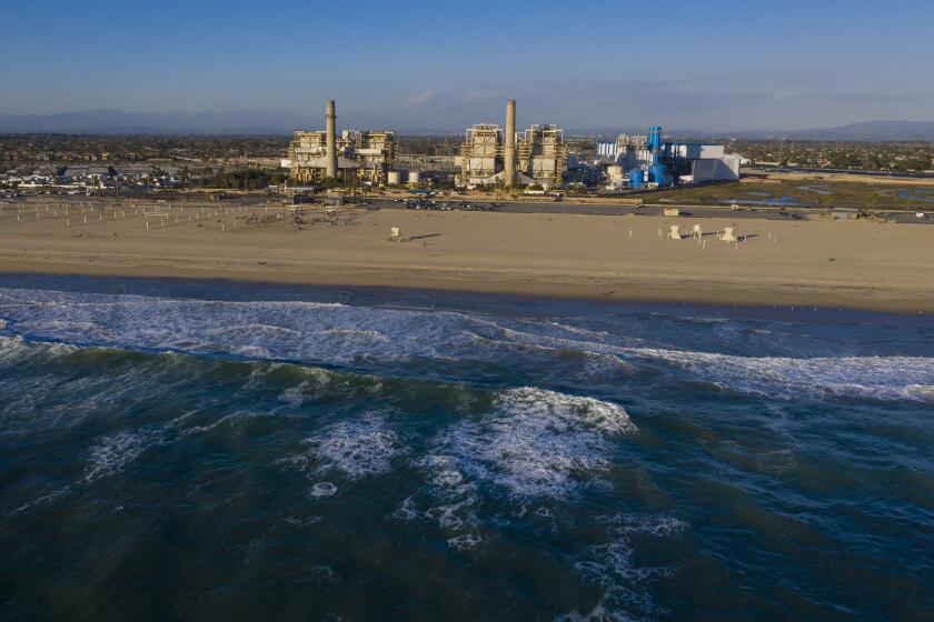 HUNTINGTON BEACH, CA - February 17: A view of the older AES Huntington Beach Power Station at left, and new one at right, and is the proposed site of the Poseidon Desalination Plant, which would draw ocean water through an existing intake pipe at Wednesday, Feb. 17, 2021 in Huntington Beach, CA. (Allen J. Schaben / Los Angeles Times)