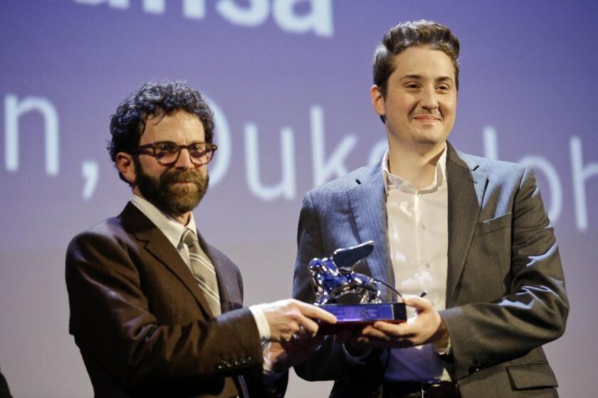 Charlie Kaufman, left, and Duke Johnson receive their Grand Jury Prize Award on Sept. 12 at the Venice Film Festival for their stop-motion film "Anomalisa."