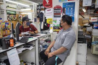 Los Angeles, Calif. -- Saturday, June 12, 2021: CIELO worker Aurora Pedro, left, talks about Covid vaccines with Francisco Hernandez, right, a worker in the Selecto Plaza Mall in Los Angeles, Calif., on June 12, 2021. (Brian van der Brug / Los Angeles Times)