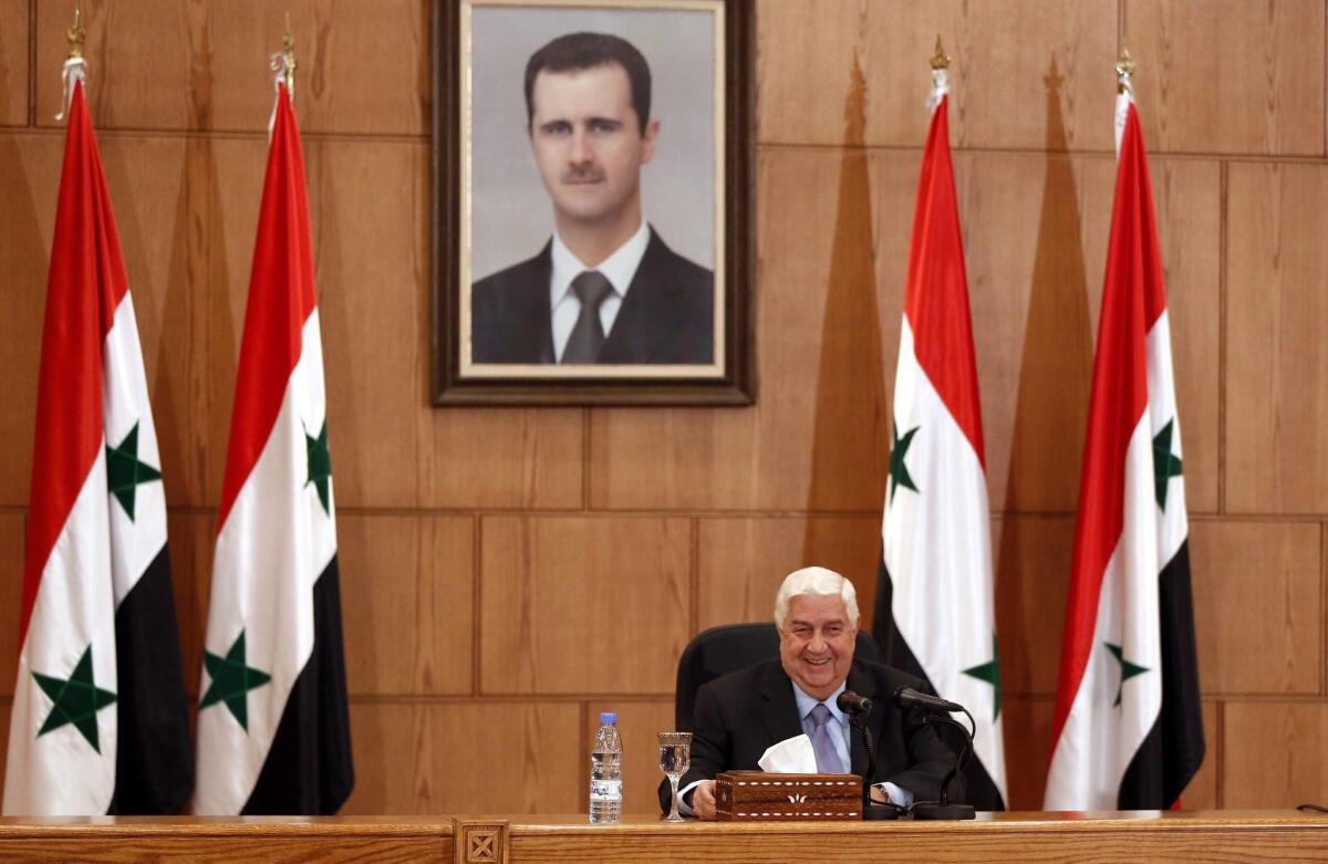 Syrian Foreign Minister Walid Moallem addresses a news conference in Damascus.