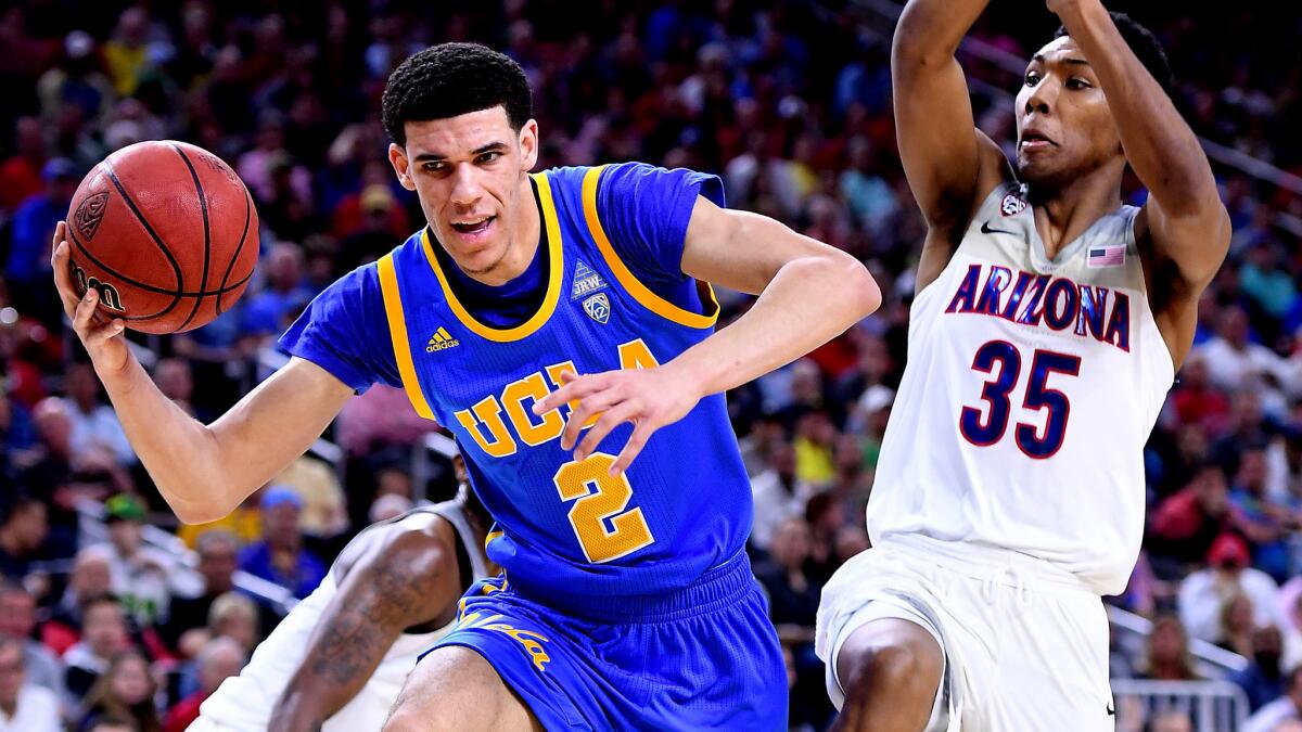 UCLA guard Lonzo Ball is fouled by Arizona guard Kadeem Allen (partially obscured) while he drives against Wildcats guard Allonzo Trier.