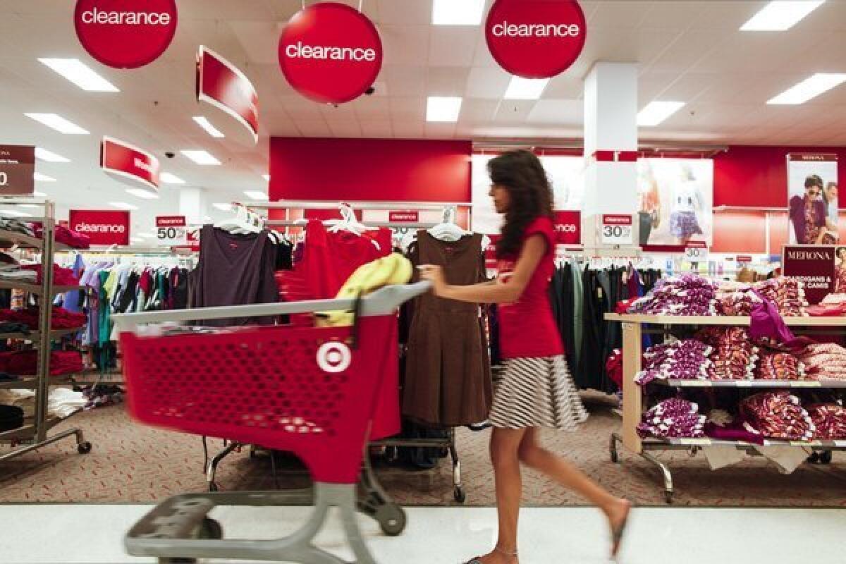 A shopper pushes a trolley through a store in Chicago. Americans spent at the fastest pace in six months in August but much of that increase went to pay their higher gas bills, the Commerce Department announced Friday.