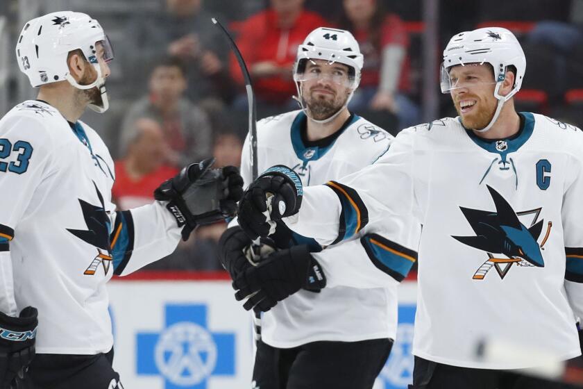 San Jose Sharks center Joe Pavelski, right, celebrates his empty net goal with Barclay Goodrow (23) in the third period of an NHL hockey game against the Detroit Red Wings, Sunday, Feb. 24, 2019, in Detroit. Pavelski scored three goals in the Sharks' 5-3 win. (AP Photo/Paul Sancya)