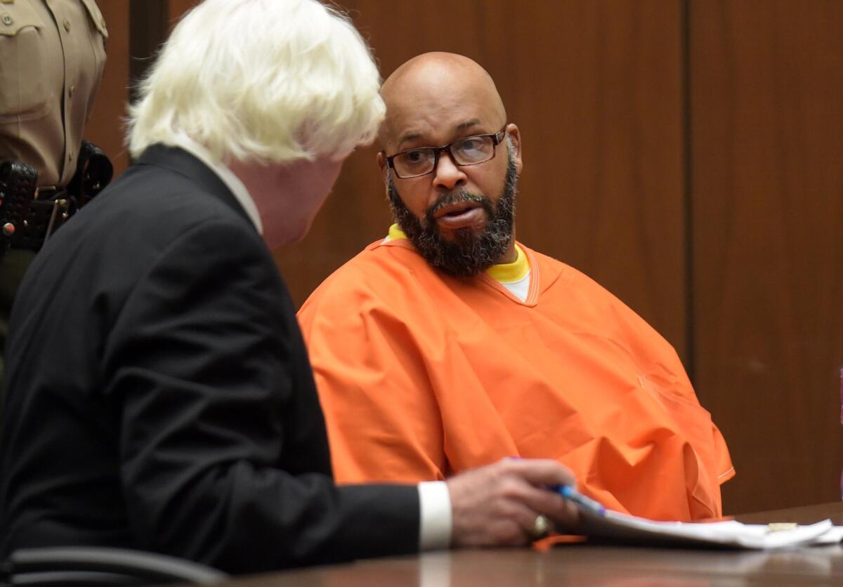 Marion “Suge” Knight appears in court during his arraignment on murder charges with his new attorney, Thomas Mesereau, in Los Angeles on Friday.
