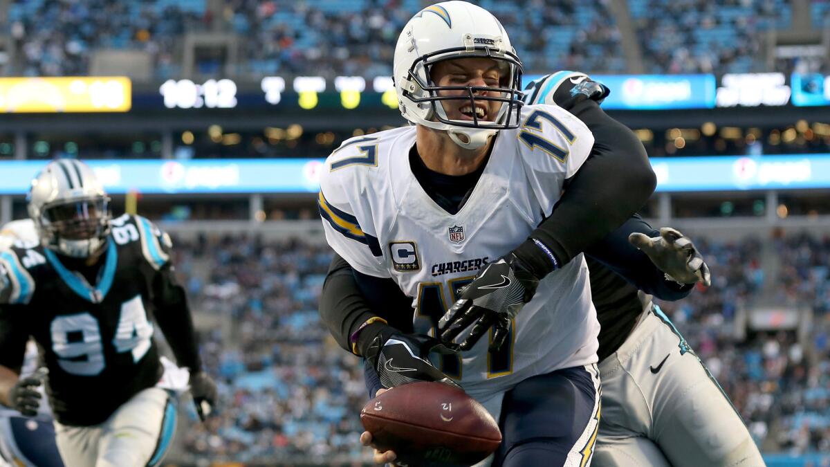 Chargers quarterback Philip Rivers is sacked by Panthers defensive end Mario Addison in the end zone for a safety during second half Sunday.