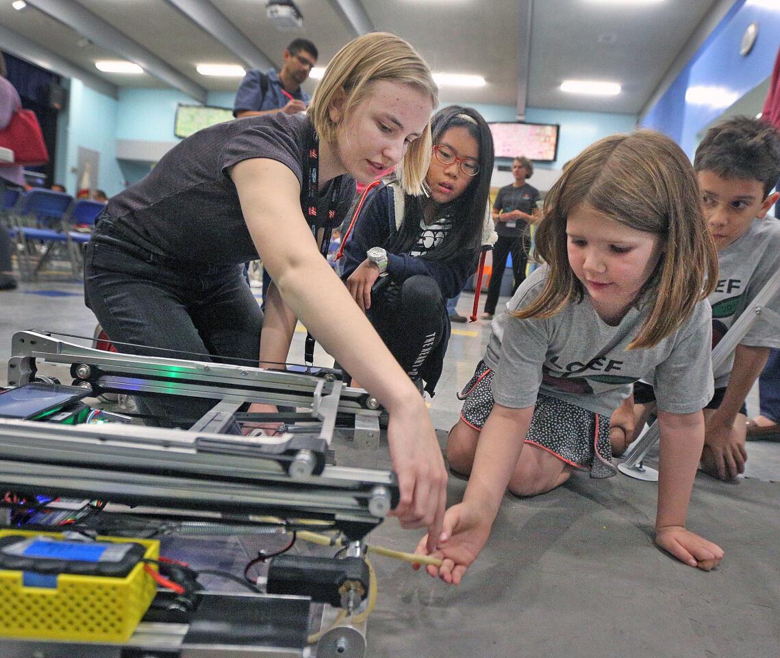 Aloy Bell, of Waverly School, goes over details of her team's robot with Yireh Ban, 10, of Palm Crest Elementary, and Holland Wolpert, 8, of Palm Crest Elementary, at a discussion open to all kindergarten through eighth grade students in the La Canada School District about InSight, the latests mission to Mars, at La Canada Elementary School on Wednesday, November 14, 2018. After the discussion, a few hands on science projects including a competitive robot, earthquake demonstrations, and discussions about the planet Mars surrounded the room.