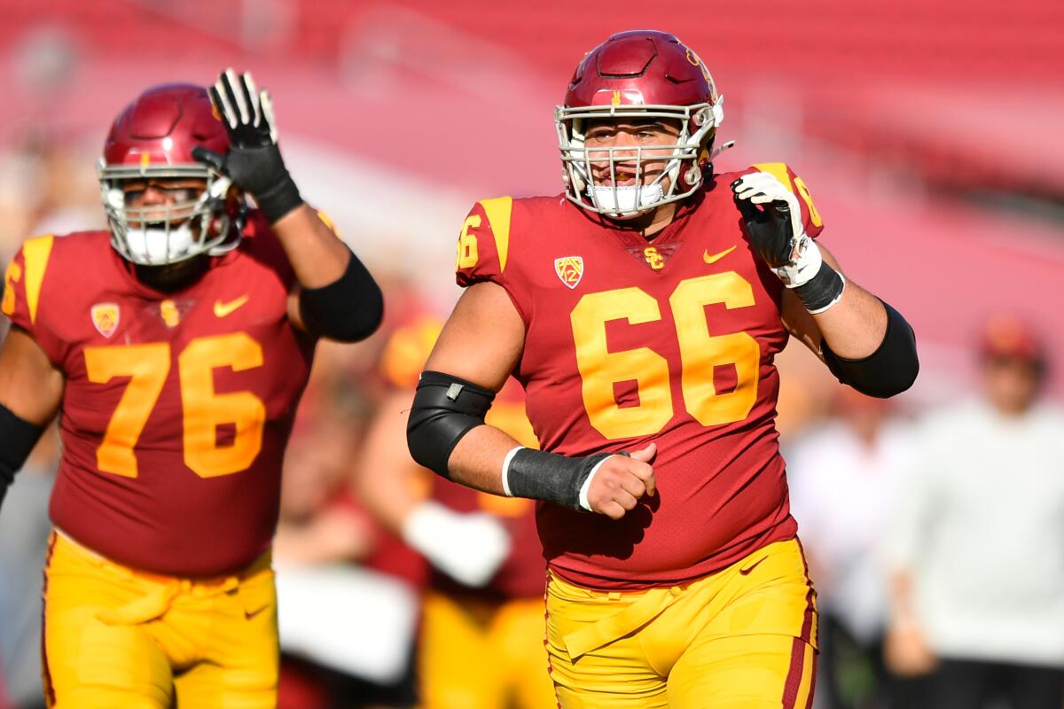 USC offensive lineman Gino Quinones (66) and Mason Murphy (76) celebrate a touchdown against Rice in September 2022.