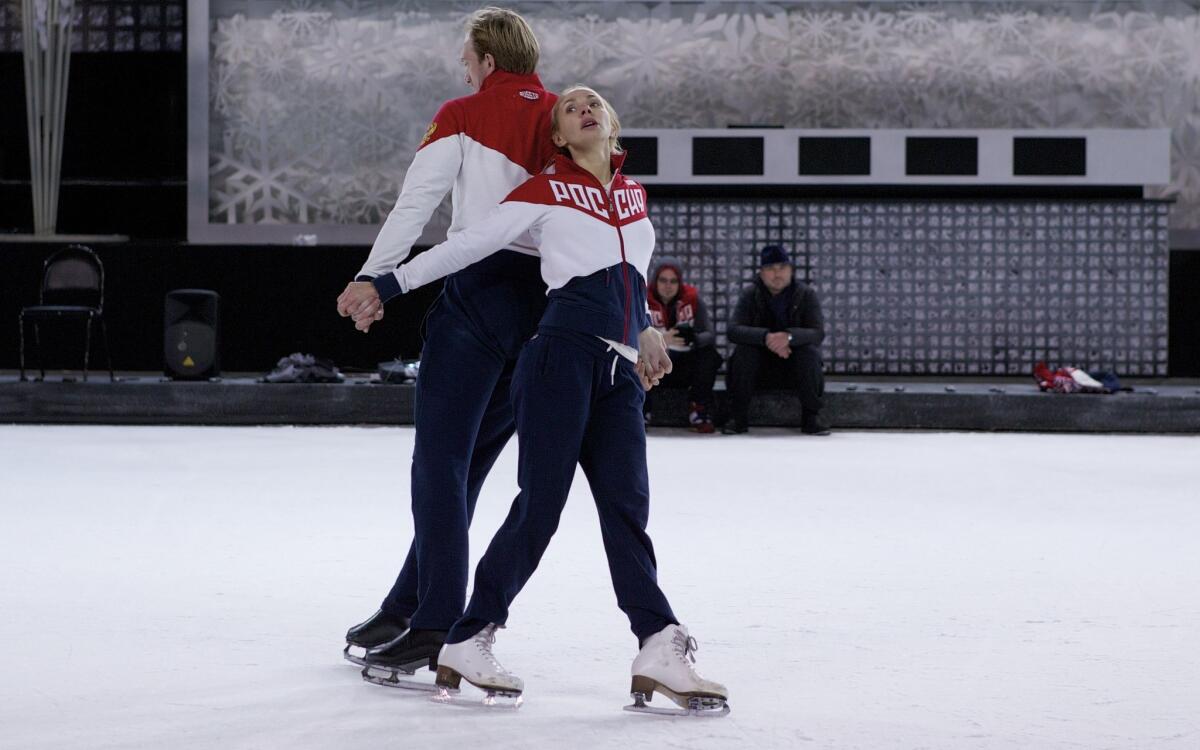 Former Russian figure skater and 2006 Olympic gold medalist Tatiana Navka, right, and her on-ice partner Andrei Burkovsky skate during a training session in Moscow, Russia, on Monday, Nov. 28, 2016. Navka and Burkovsky have caused controversy by dressing up in concentration camp uniforms for a routine on a popular television show. Later they've said it was their way of paying homage to Holocaust victims. (AP Photo/Alexander Zemlianichenko)