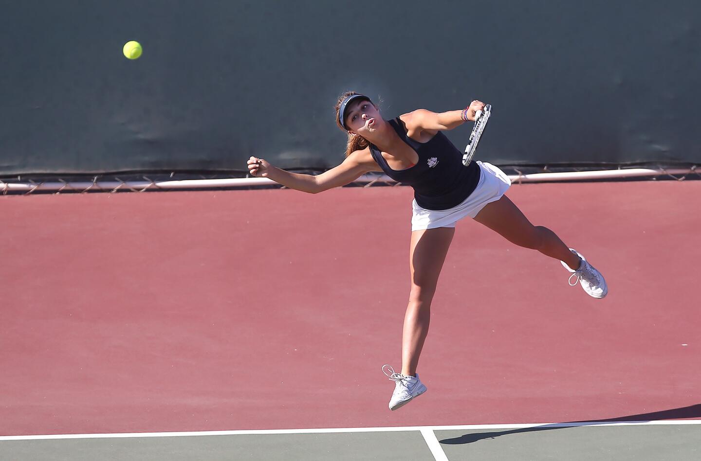 Newport Harbor doubles player Amra Barton serves during first round of the CIF Southern Section Division 1 playoffs against San Clemente on Wednesday