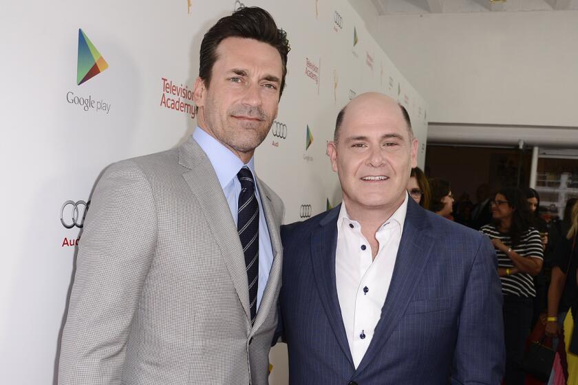 Actor Jon Hamm, left, and "Mad Men" creator, director, executive producer and writer Matthew Weiner explore "The Mad Men Experience" from Google Play at the TV Academy's "Farewell to Mad Men" event at the Montalban Theater in Hollywood.