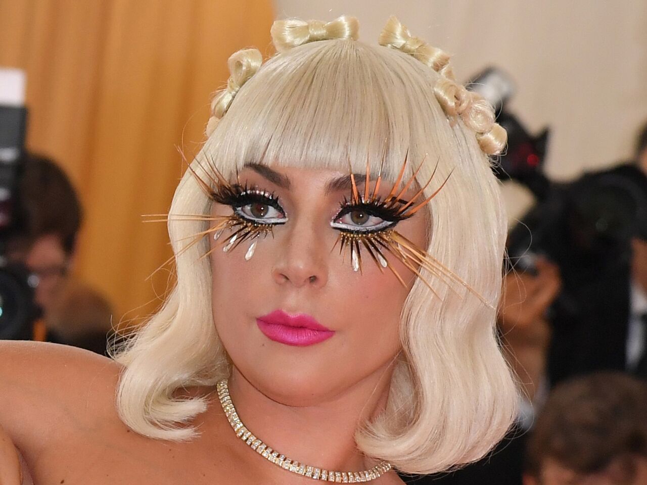 Lady Gaga owned the pink carpet with multiple outfit reveals. Her butterfly-like black-and-gold lashes also were a stunner.