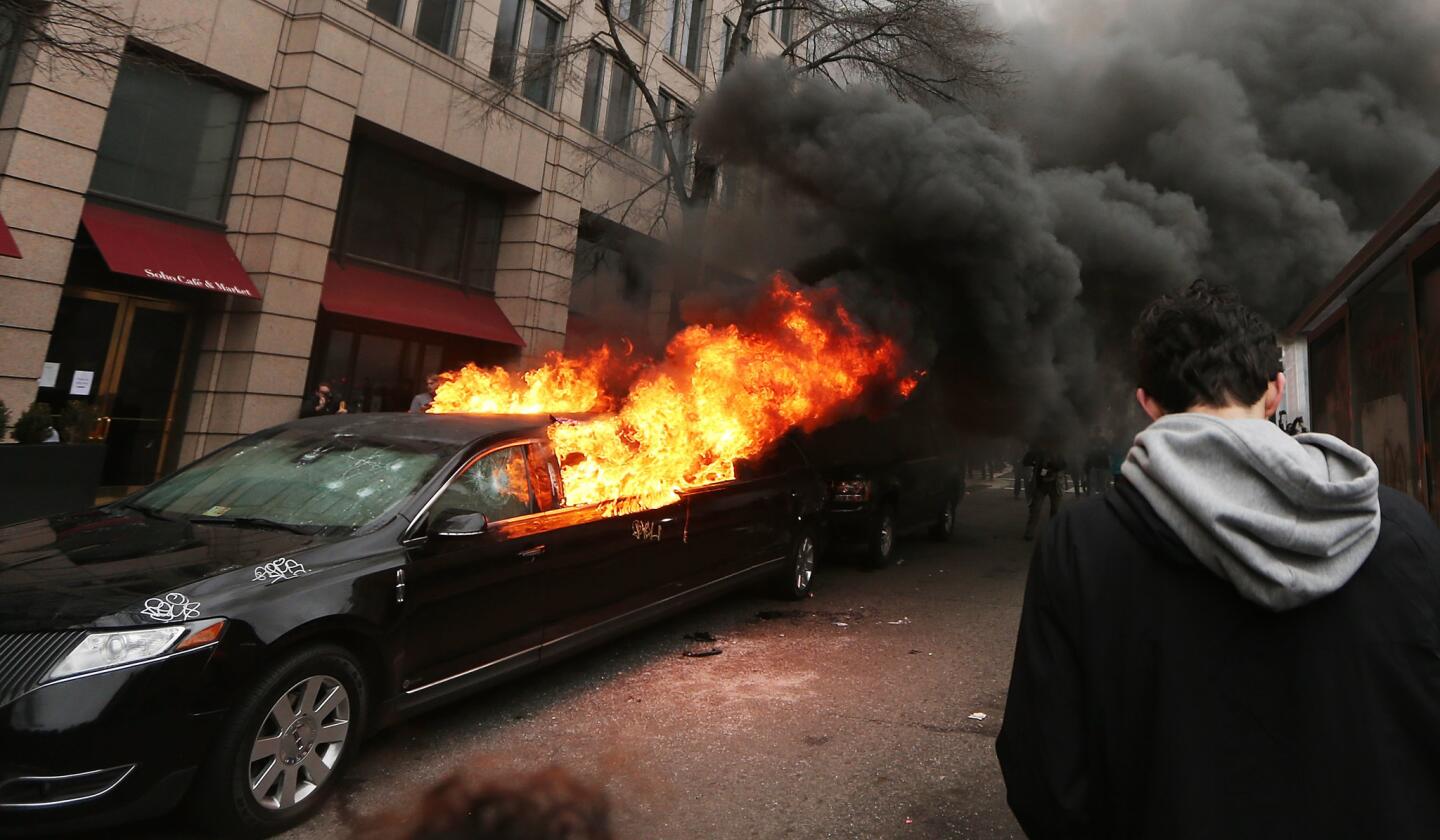 A limousine burns by anti-Trump protesters on K Street in Washington, DC.