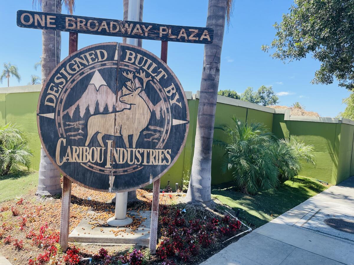 A sign reads One Broadway Plaza and has a moose