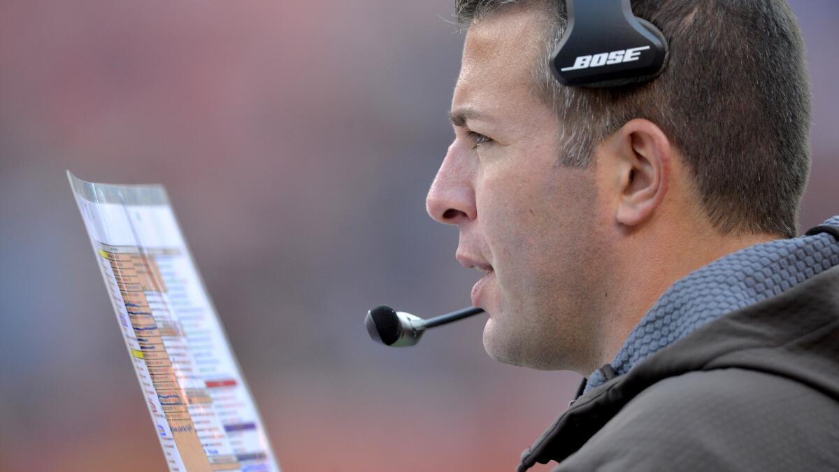 Browns offensive coordinator John DeFilippo checks his color-coded play card during a game against the Bengals on Dec. 6.