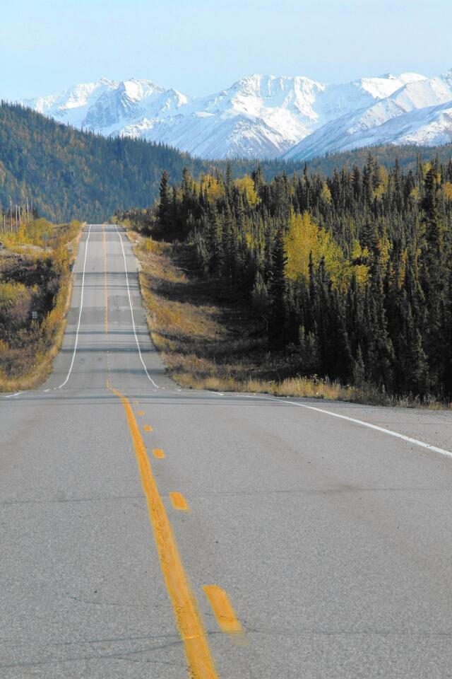 The Alaska Highway descends into the Muskwa River Valley, British Columbia. Because travelers are crossing borders, they need to have their passports with them (including passports or IDs for minors).
