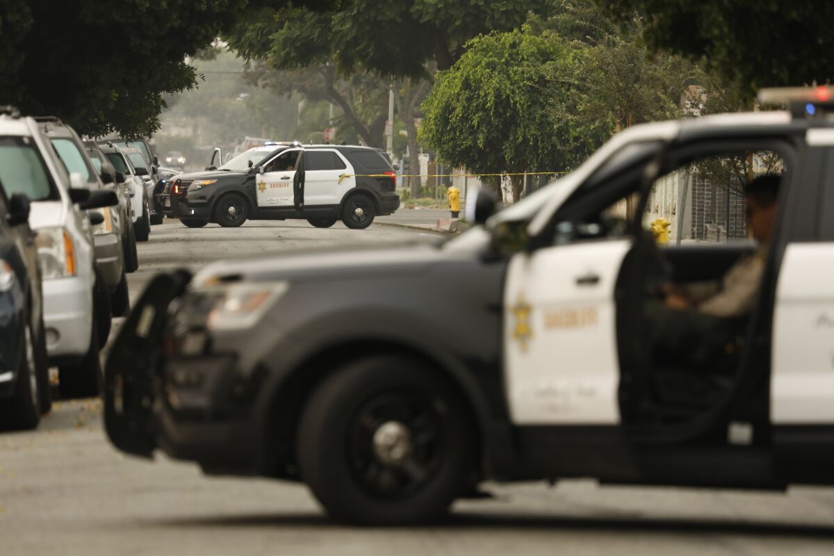 Los Angeles County Sheriff's deputies at a crime scene.