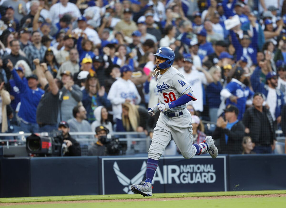 Dodgers star Mookie Betts rounds the bases after hitting a tying home run in the ninth inning.
