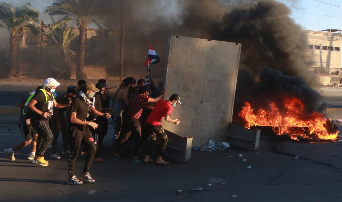 Anti-government protesters set fires during a demonstration in Baghdad on Friday.