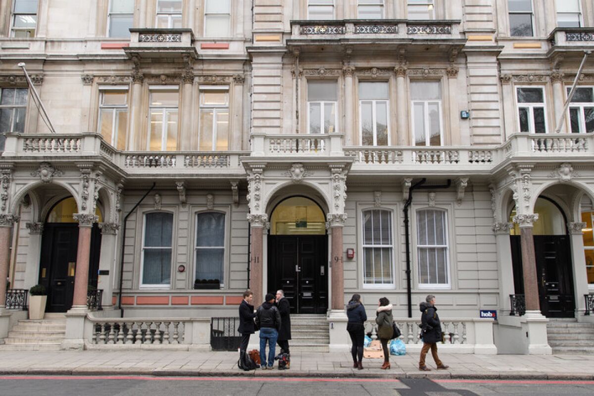 Journalists gather outside the London headquarters of Orbis Business Intelligence, the company run by British former intelligence officer Christopher Steele.