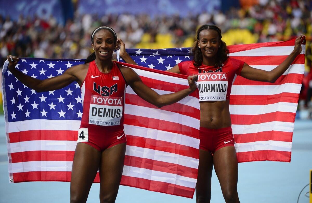 U.S. teammates Dalilah Muhammad, right, and Lashinda Demus celebrate after taking silver and bronze, respectively, in the women's 400-meter hurdles at the world championships Thursday in Moscow.