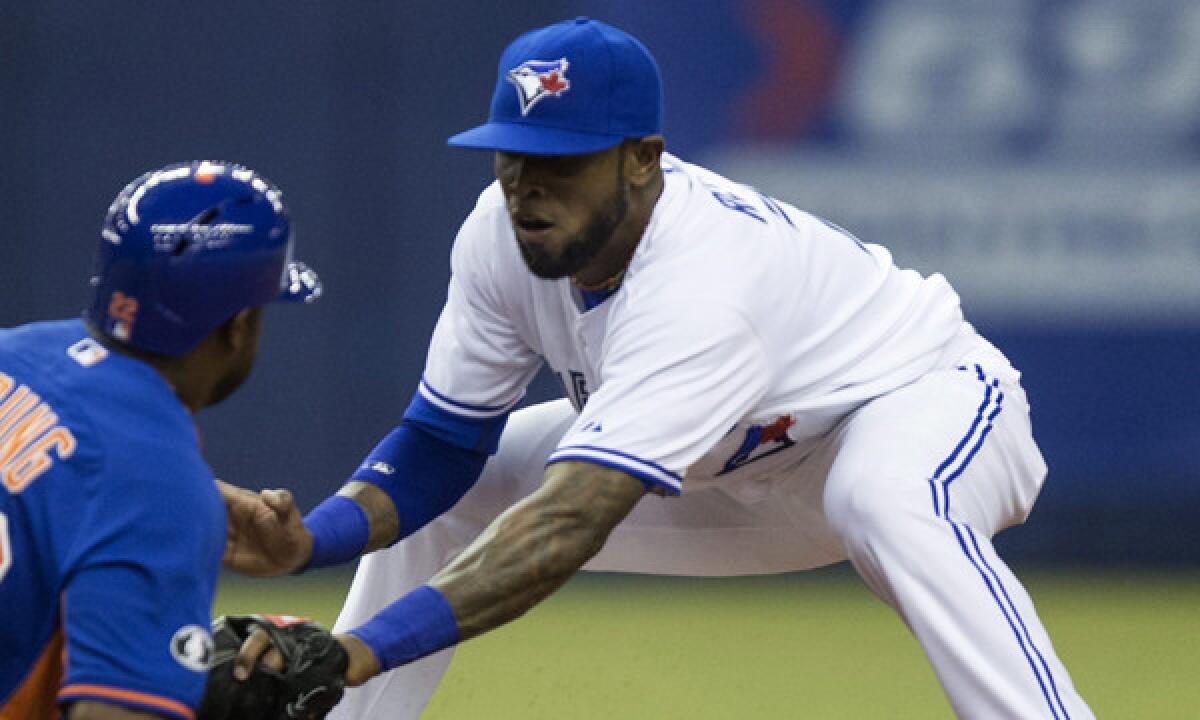 Toronto Blue Jays shortstop Jose Reyes, right, tags out New York Mets baserunner Eric Young during an exhibition game in Montreal on Friday. Reyes was injured in the Blue Jays' season opener Monday.