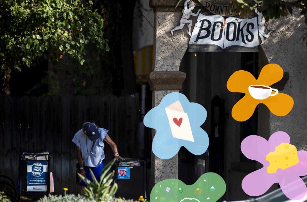A person leans over a table next to a shop with the sign "Downtowne Books." Illustrated flowers are in the foreground.