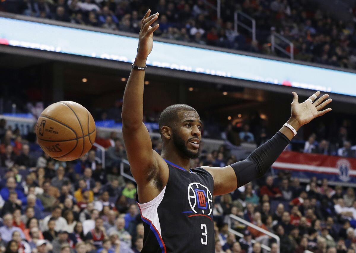 Clippers guard Chris Paul reacts after dunking the ball during the first half of a game against the Wizards.