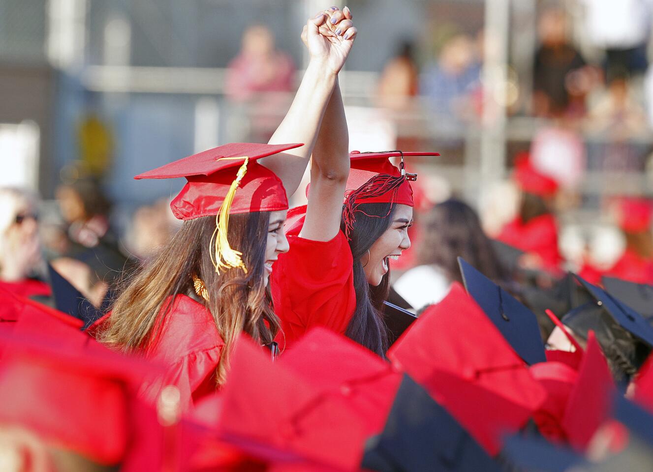 Glendale High School graduates Brenda Cocic and Andie Rodeo celebrate together after graduating at the graduation of the Glendale High School class of 2018 on Wednesday, June 6, 2018.