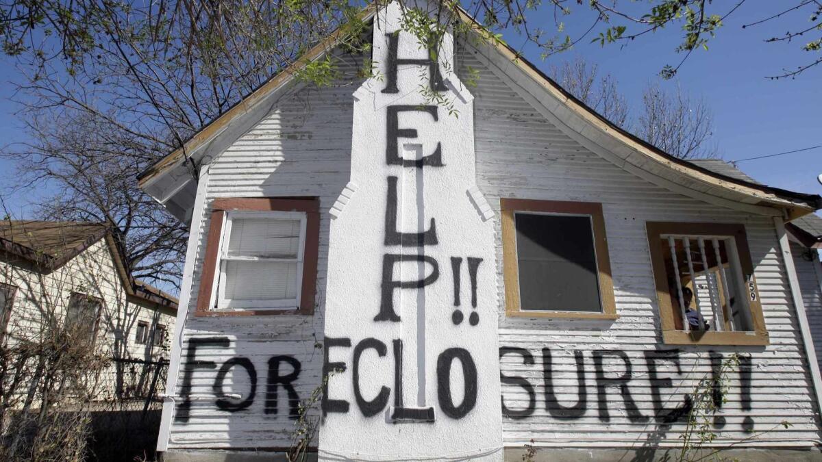 A San Antonio home facing imminent foreclosure in 2009 bears a message that reflects the desperation of that time.