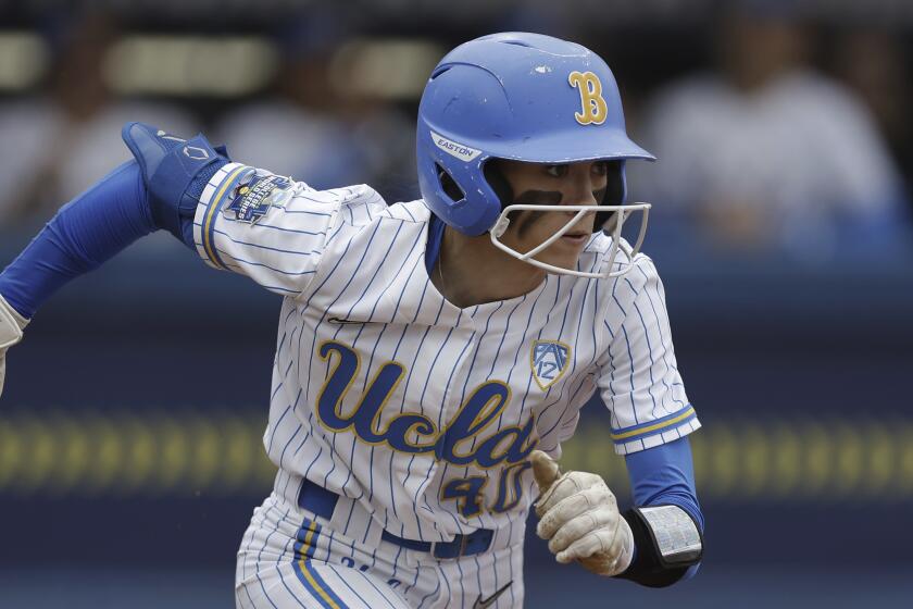 UCLA's Jadelyn Allchin (40) runs to first during an NCAA softball Women's College World Series.